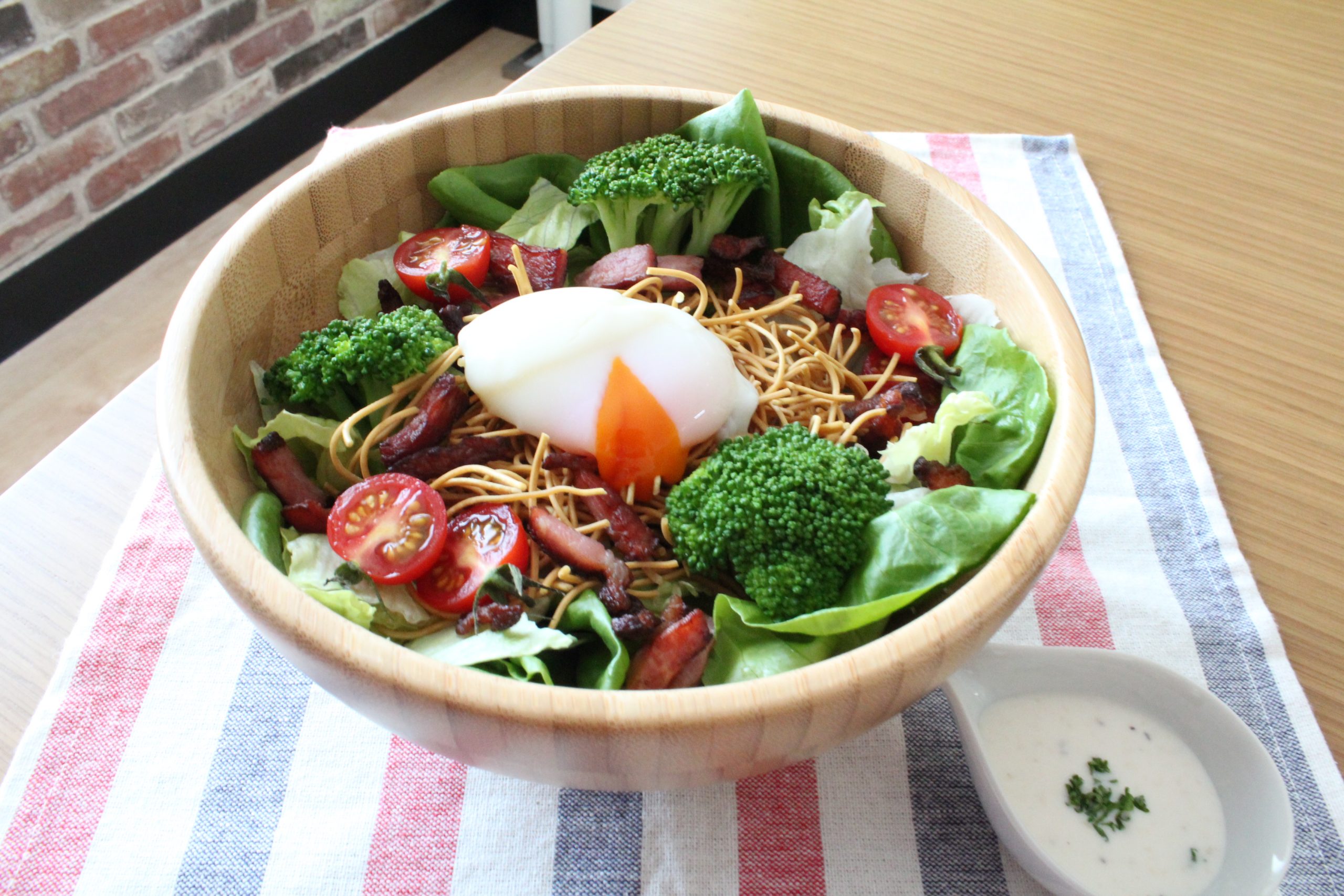 ※温泉たまごを盛り付けやすいようにパリパリ麺の中央を少し崩しておく。
好みのドレッシングを準備すれば完成です。